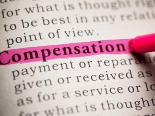 Closeup on a book with the word "Compensation" highlighted.