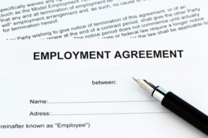 "Employment Agreement" sheet with a pen on top of it.