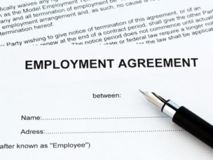 "Employment Agreement" sheet with a pen on top of it.
