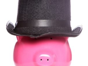 Piggy bank wearing top hat on white background.