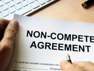 "Non-Compete Agreement" written on the top of a paper.