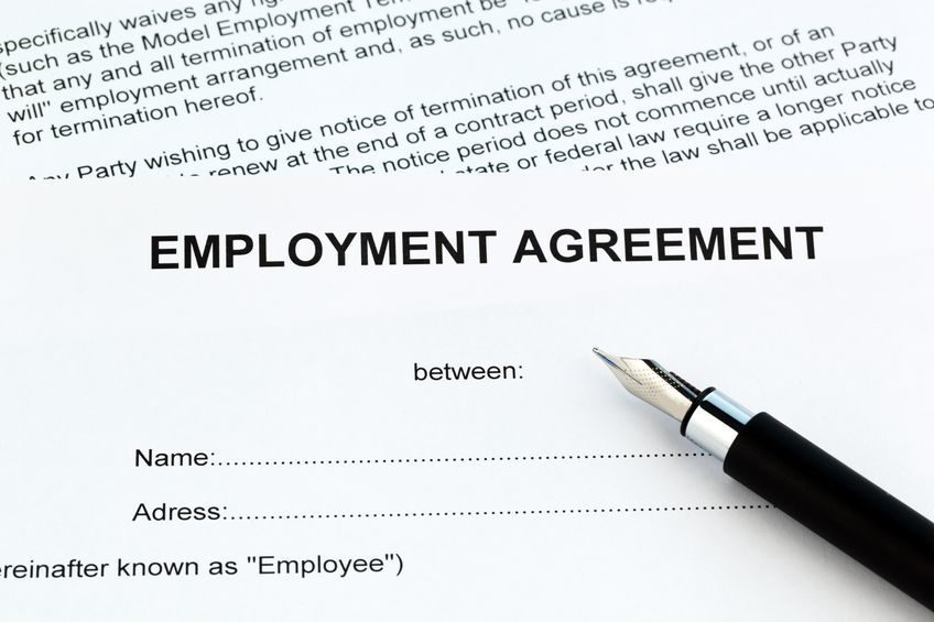 Document reading "Employment Agreement" with a pen on top of it