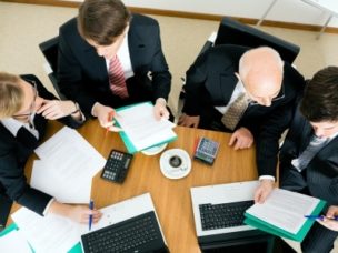 a group of men from birdeyes view at a meeting