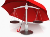 a red umbrella covering a justice scale