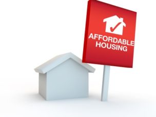 Icon to represent "Affordable Housing" with a miniature home and sign next to it.