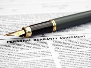 personal guaranty agreement with a black and gold pen on top