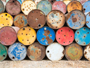 multicolored tanks holding hazardous materials turned on their sides and stacked