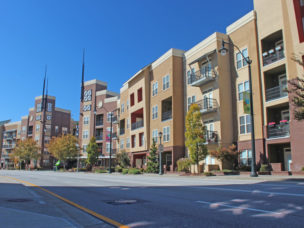 tan townhomes with a street in front of them