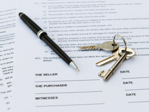 a paper with a black pen and keys on top