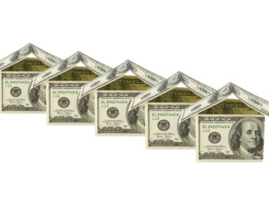 five miniature houses made out of 100 dollar bills