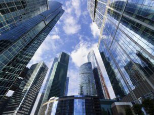 modern business office skyscrapers, looking up at high-rise buildings in commercial district, architecture raising to the blue sky with white clouds, bottom view