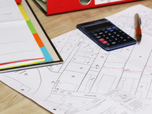 zoning map with calculator and pencil