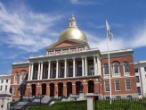 mass state house, a brick building with a gold dome on the top and a blue sky in the background